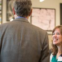 A group of people talking to each other.